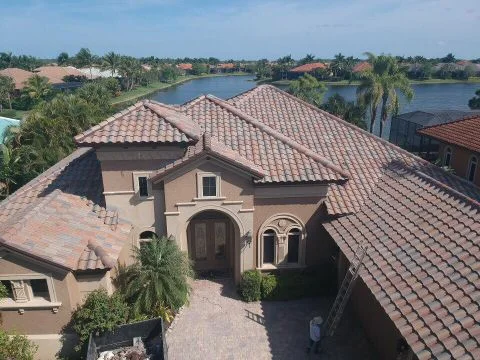 Aerial view of tile roof by a lake